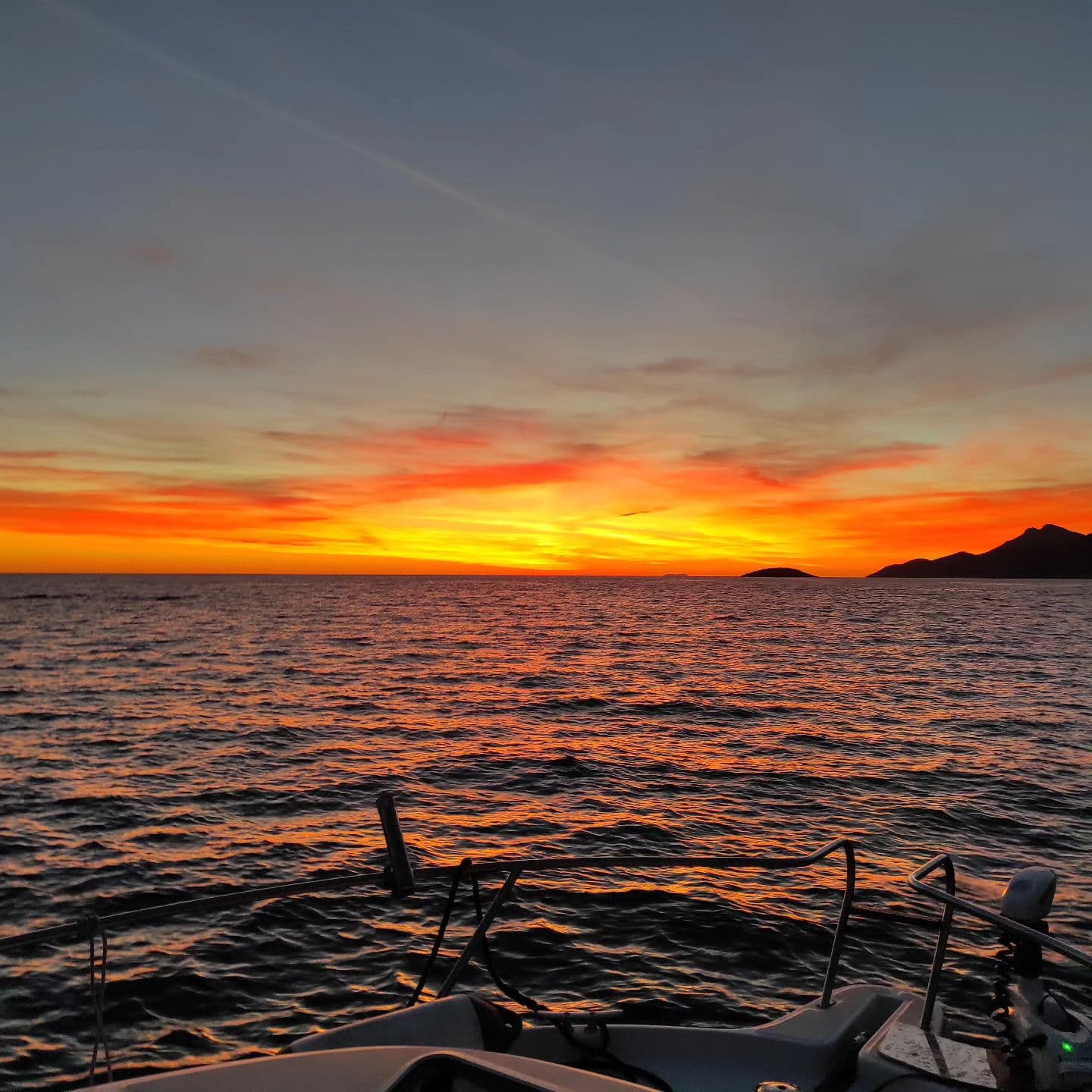 The sun setting over the sea, seen from the boat